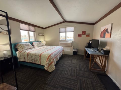 Comfortable guest room at Hotel LaBonte in Douglas, WY with large bed and scenic windows.