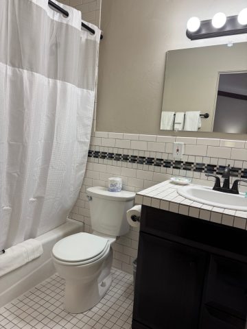 Clean bathroom with shower, toilet, and vanity at Hotel LaBonte in Douglas WY.