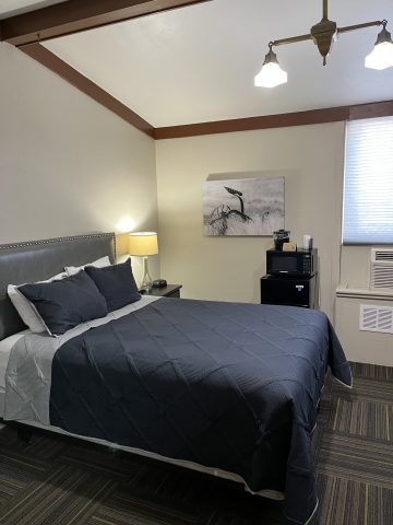 Hotel room at LaBonte with bed, artwork, and window view in Douglas WY.