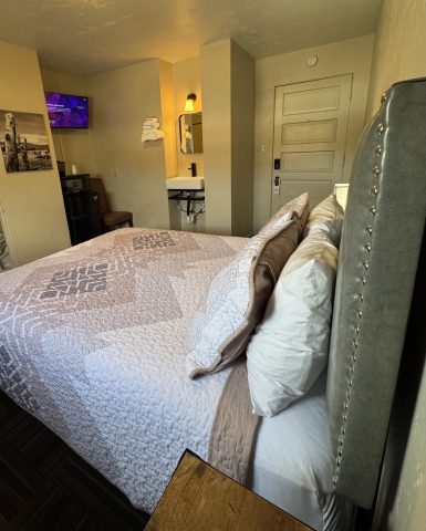 Comfortable queen room with plush bedding and modern decor in Douglas, WY.