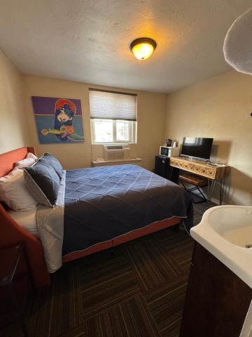 Cozy queen room in historic Douglas hotel with modern amenities.