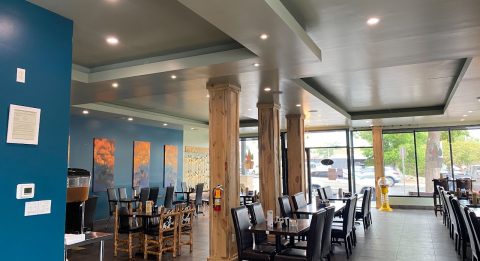 Interior view of Hotel LaBonte with dining tables and large windows in Douglas WY.