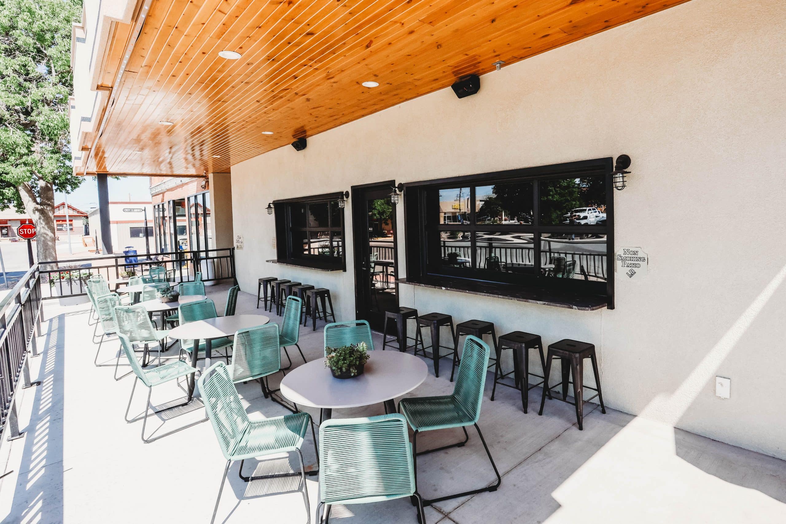 Outdoor patio with tables and chairs at Hotel LaBonte in Douglas, WY.