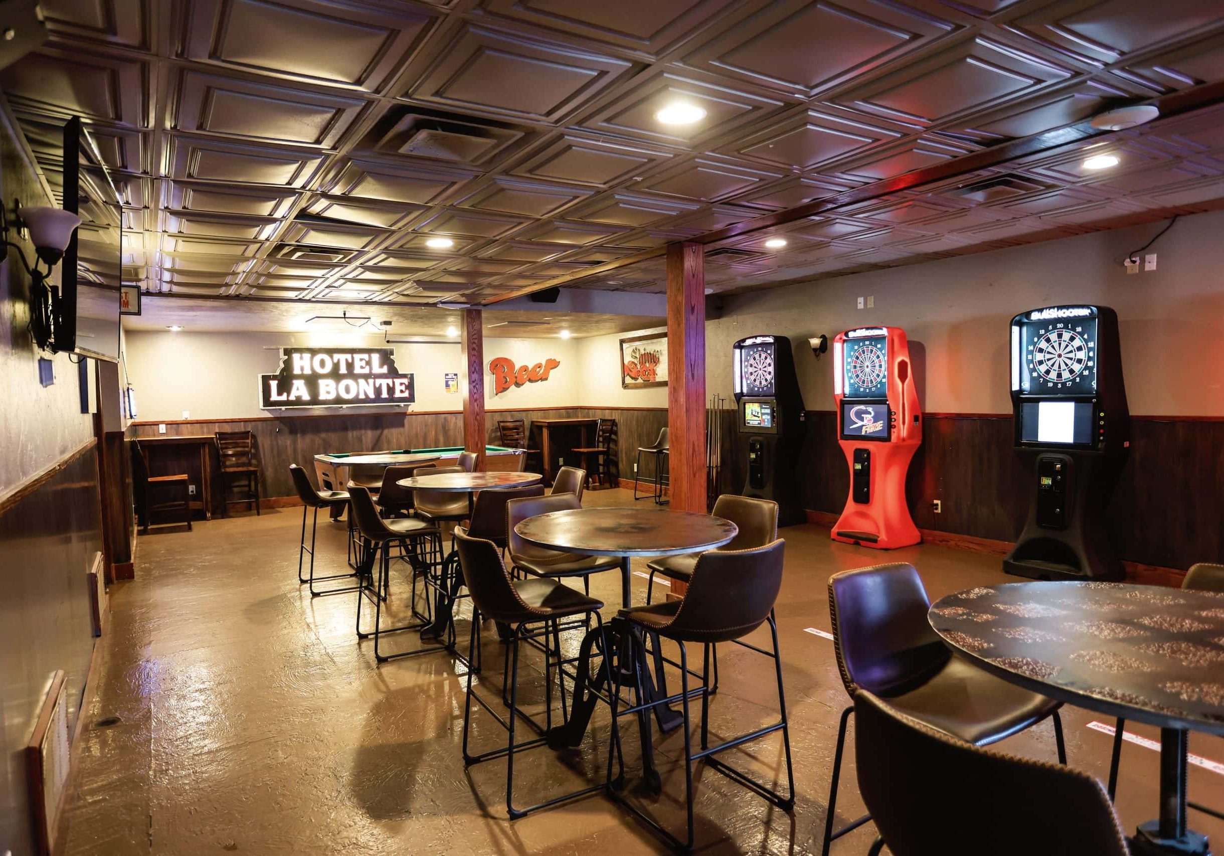 Indoor view of Hotel LaBonte's lounge with darts and gaming machines in Douglas WY.