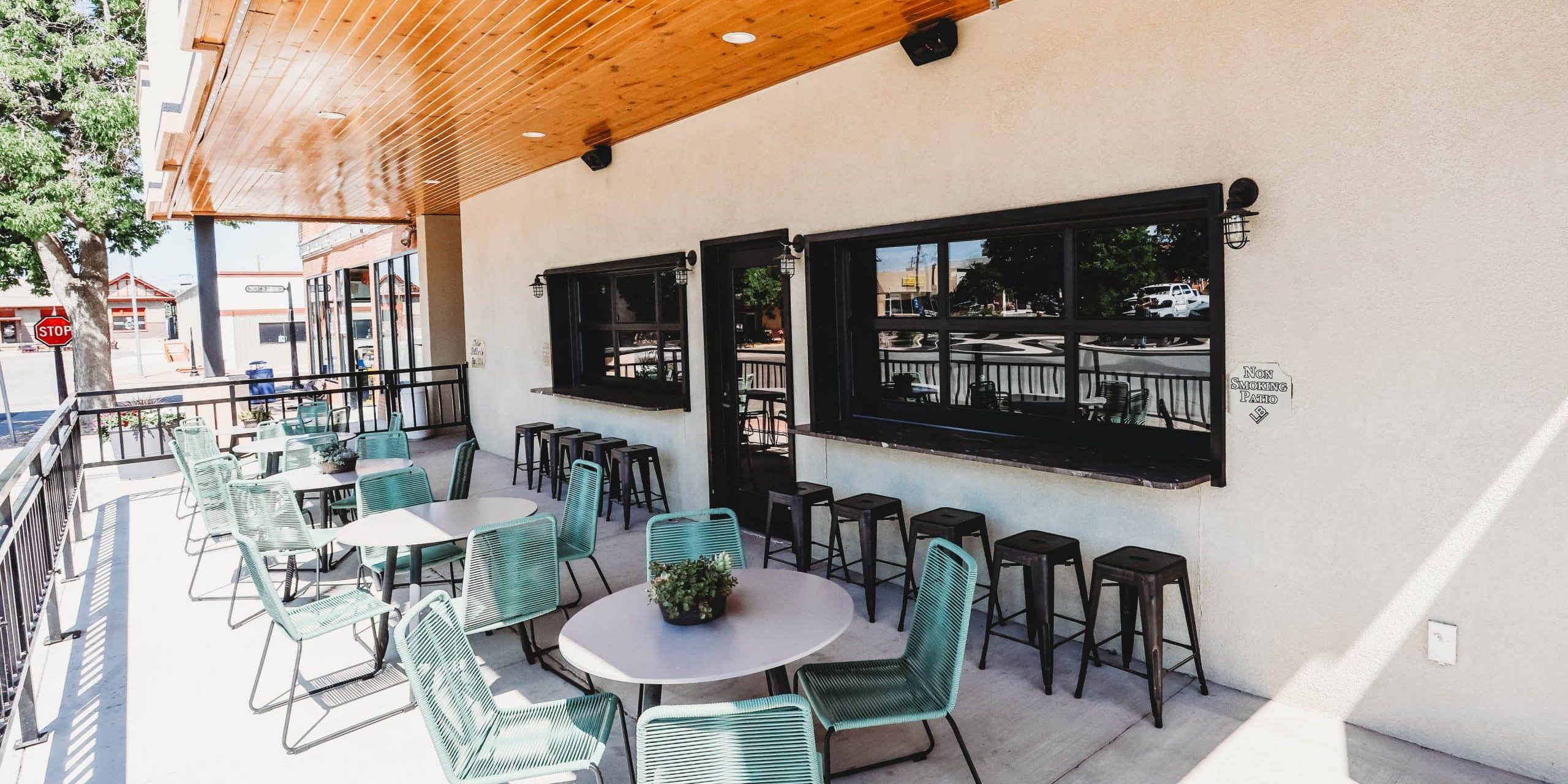 Outdoor patio with tables and chairs at Hotel LaBonte in Douglas, WY.