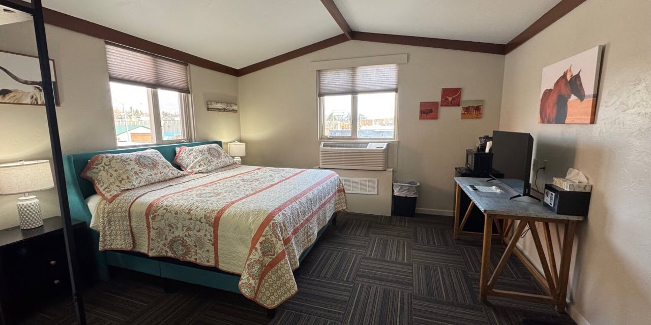 Comfortable guest room at Hotel LaBonte in Douglas, WY with large bed and scenic windows.