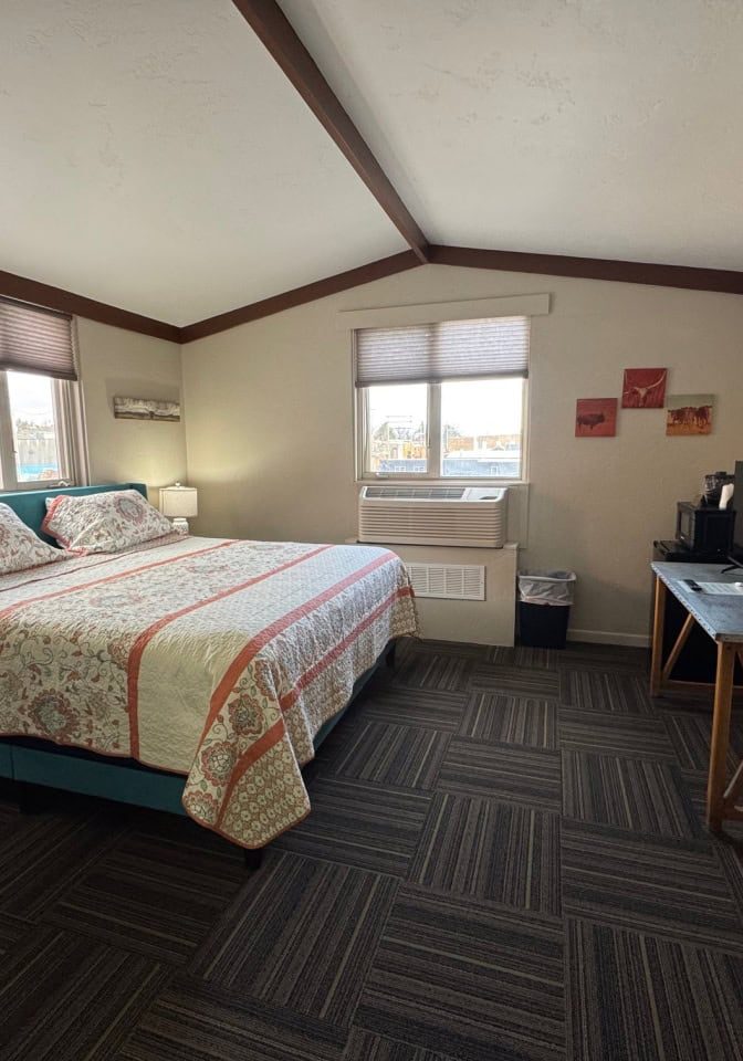 Comfortable guest room at Hotel LaBonte in Douglas, WY with large bed and scenic windows.