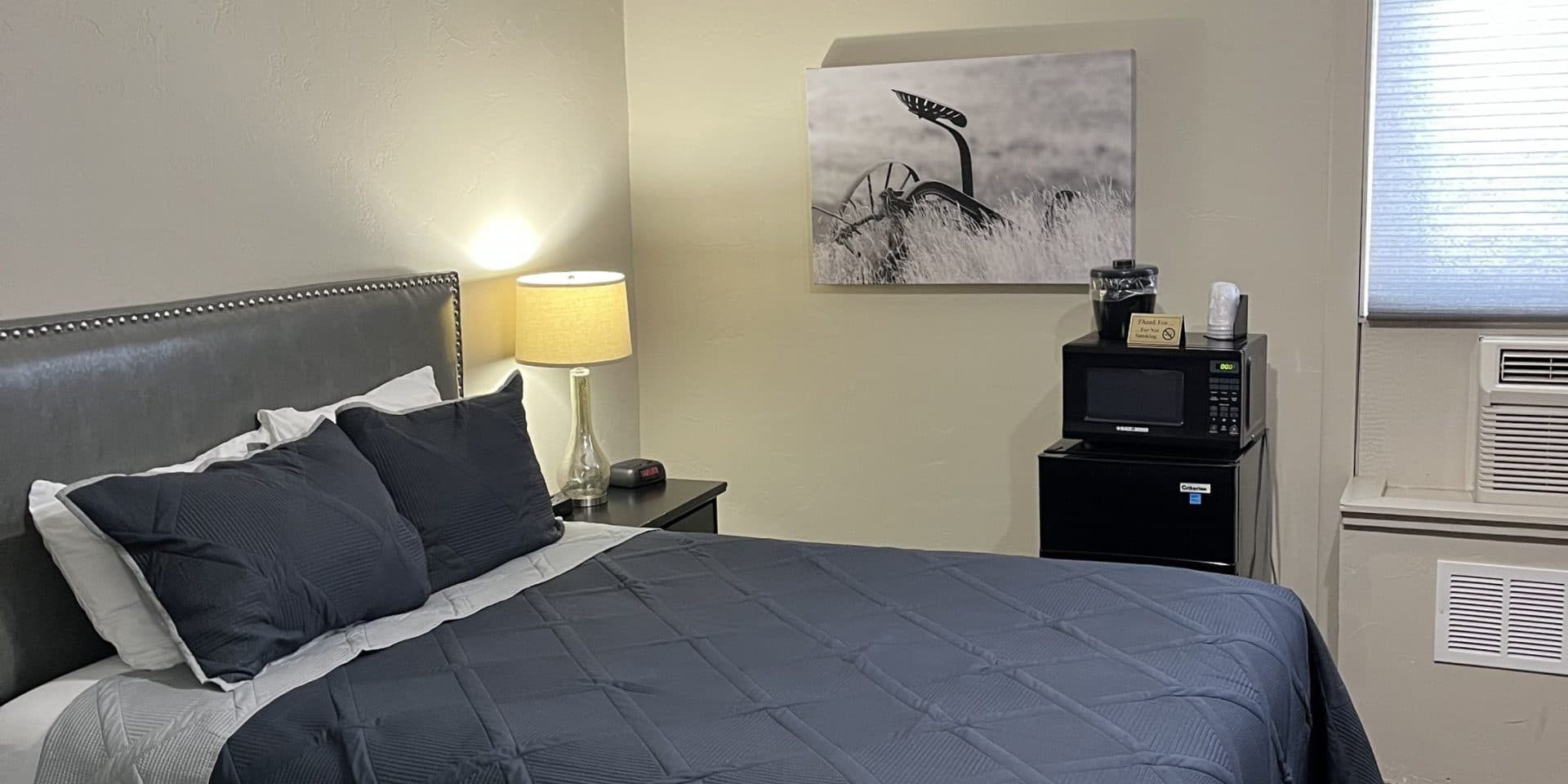Hotel room at LaBonte with bed, artwork, and window view in Douglas WY.