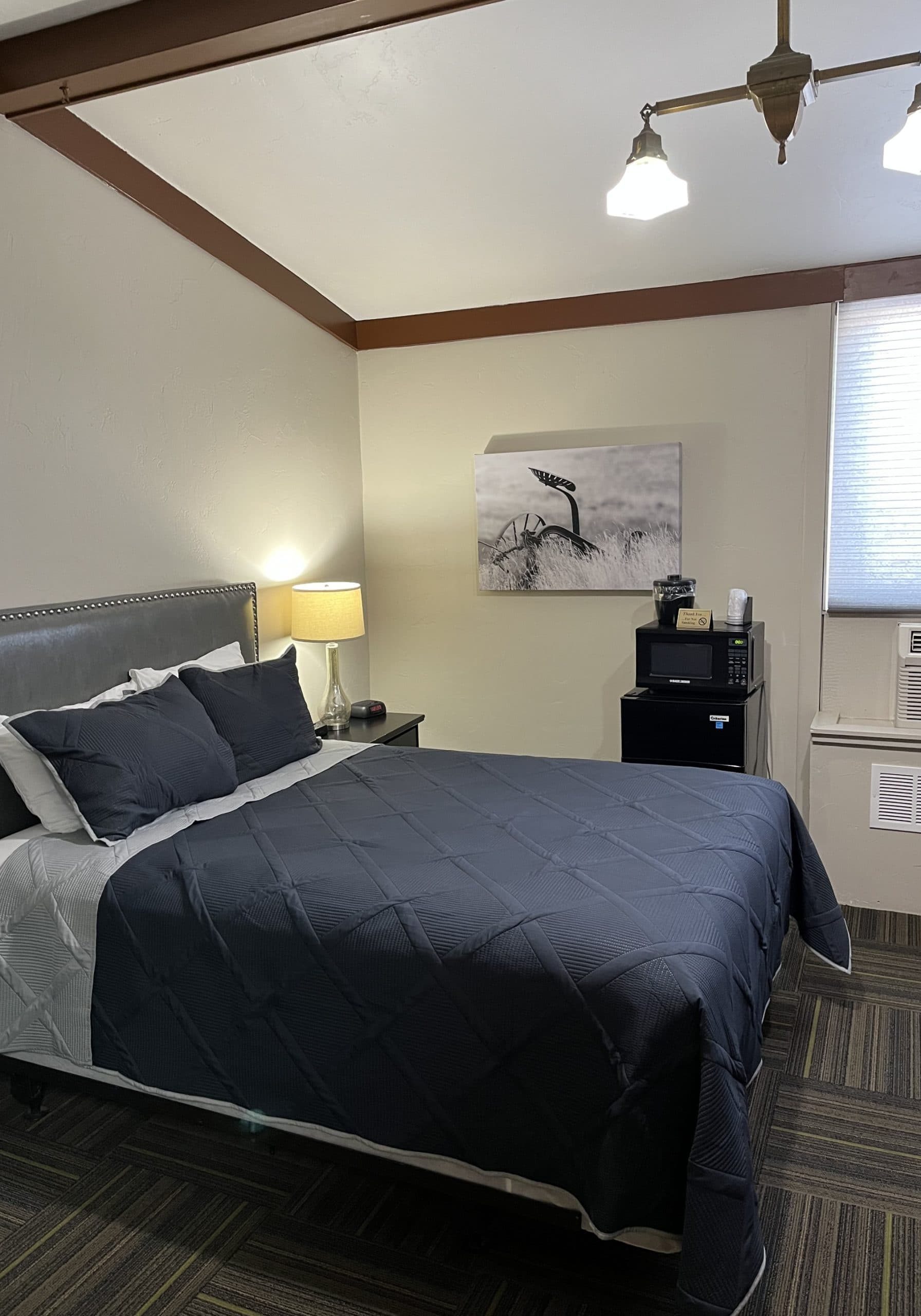 Hotel room at LaBonte with bed, artwork, and window view in Douglas WY.